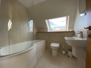 Big bathroom with skylights and a tub