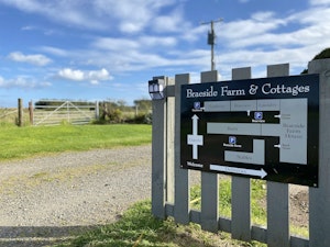 Cottage sign with locations at the entrance of the property