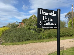 Cottage sign on the road outside the property